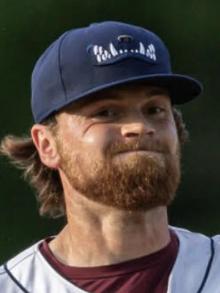 Headshot photo of Collin Floyd in a blue baseball cap actively pitching.